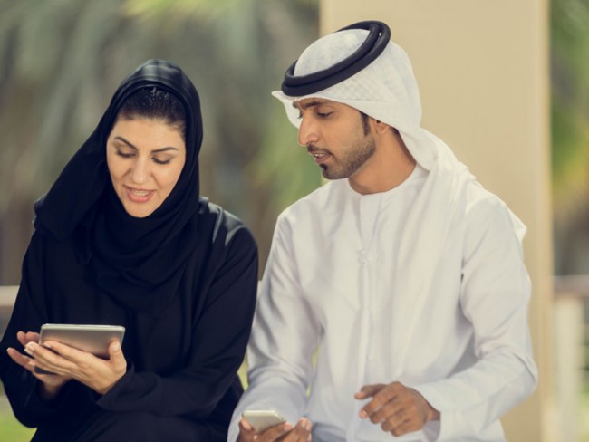 Man and woman looking at mobile device